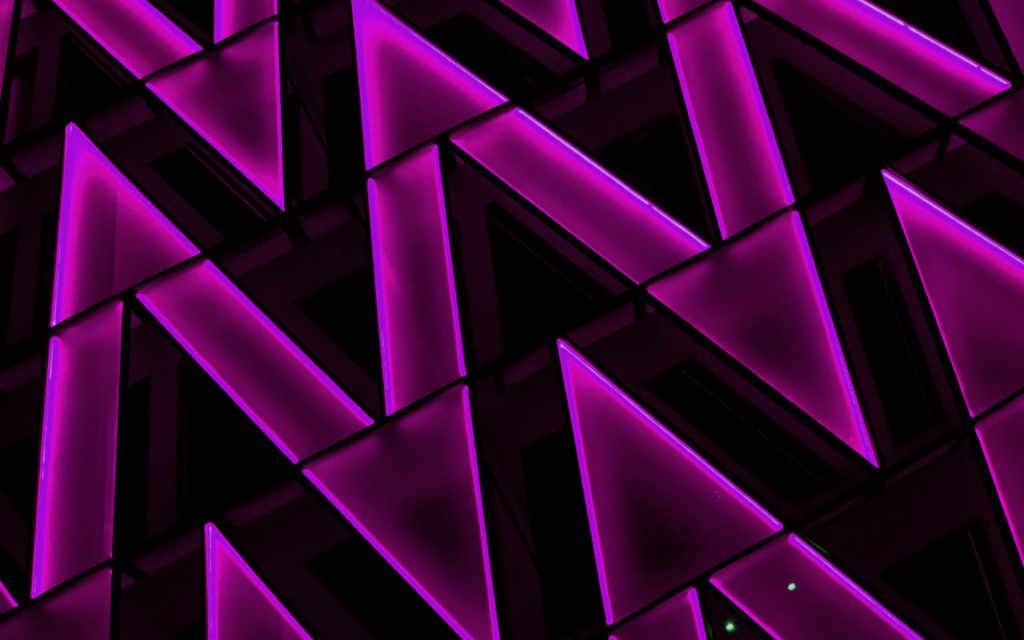A vibrant pattern of purple neon lights in a geometric design, symbolizing the dynamic and innovative nature of creative industries that thrive with specialized accounting services.
