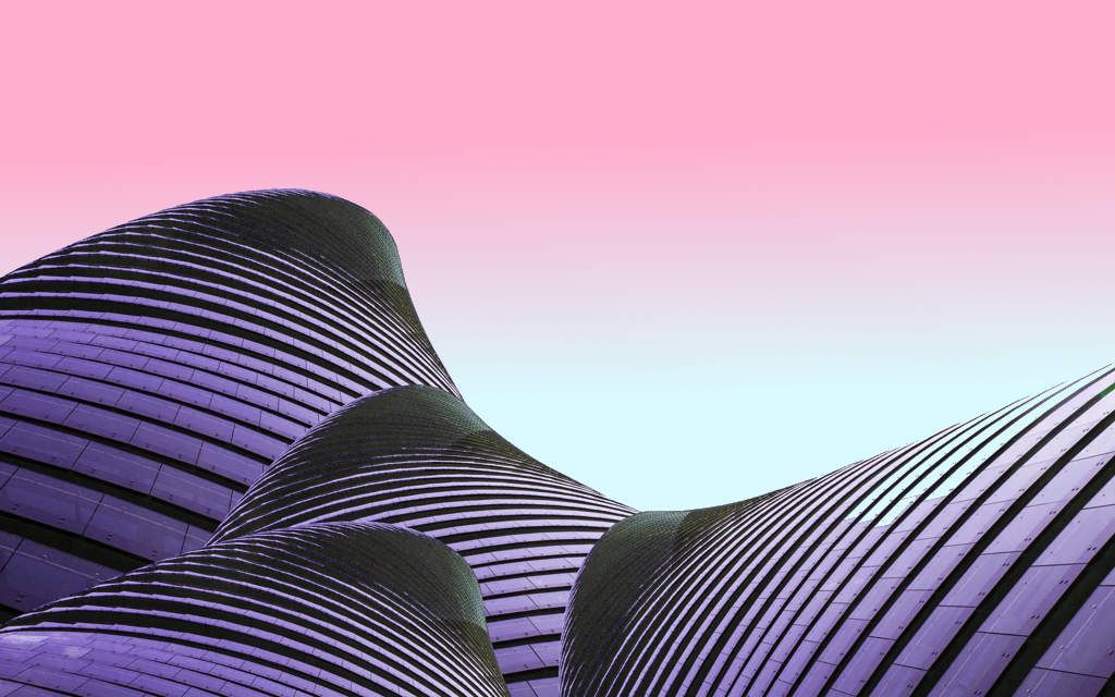 Modern curved architecture building with horizontal lines against pink gradient sky - accounting services for architects and creative design firms