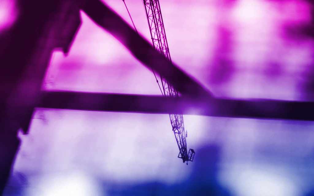 Construction crane reflection in water with purple sky backdrop - accounting services for architects and creative construction businesses
