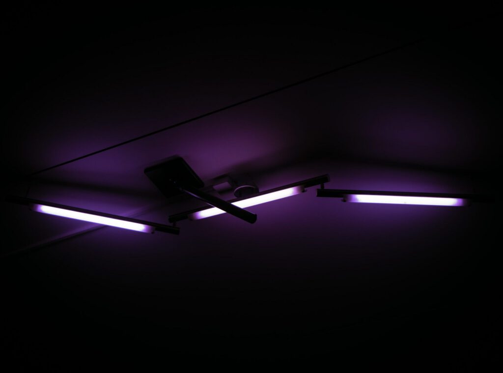 Modern ceiling fan with purple LED strip lighting in dark room - accounting services for interior designers and creative home professionals
