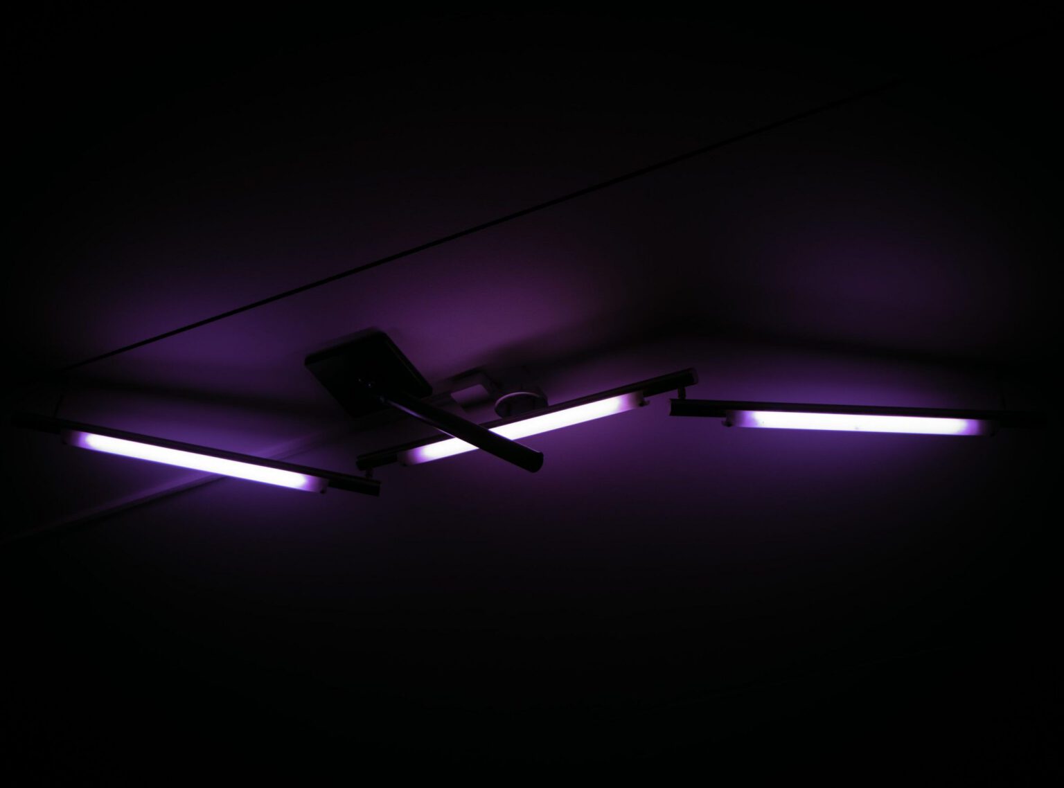 Modern ceiling fan with purple LED strip lighting in dark room - accounting services for interior designers and creative home professionals
