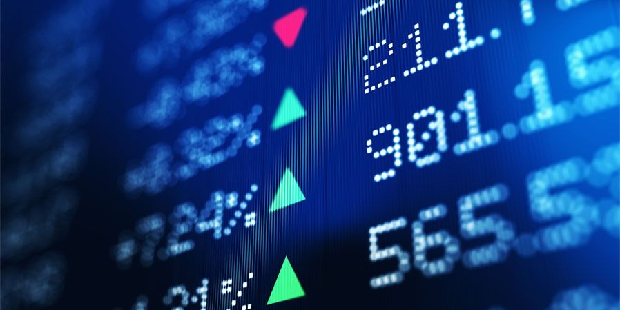 A close-up of a digital stock market display showing fluctuating numbers and indicators, representing financial data and the importance of informed accounting for creative businesses.
