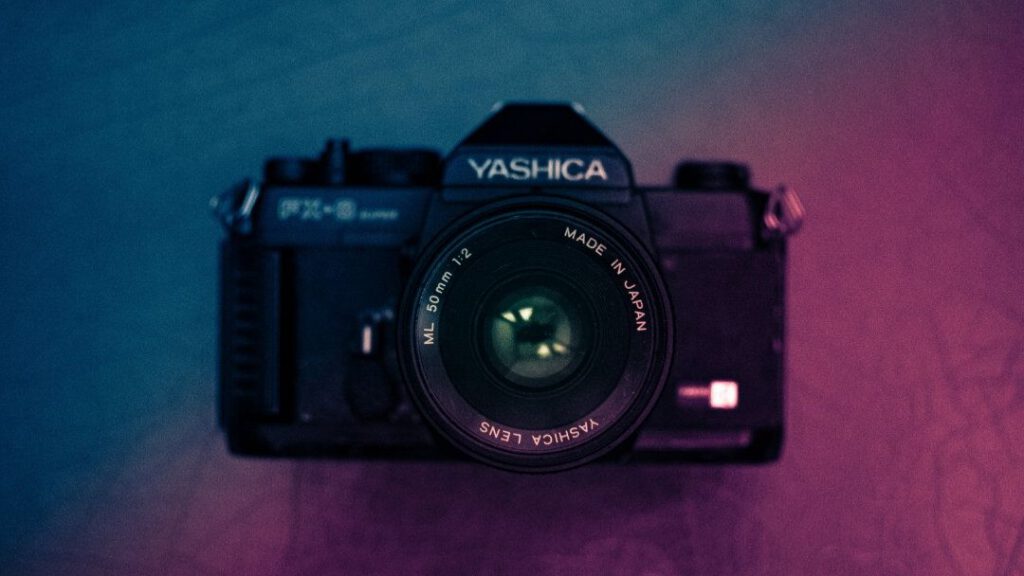 Vintage Yashica film camera with blue and purple gradient lighting - accounting services for photographers and visual media professionals